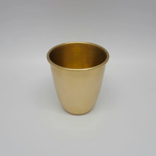 Slightly high angle view showing the smooth rim and 300ml capacity of the matte brass glass.
