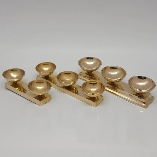 A stacked arrangement of multiple pure brass connected multi-bowl stands showcasing both the dual cup and triple cup layout options together.