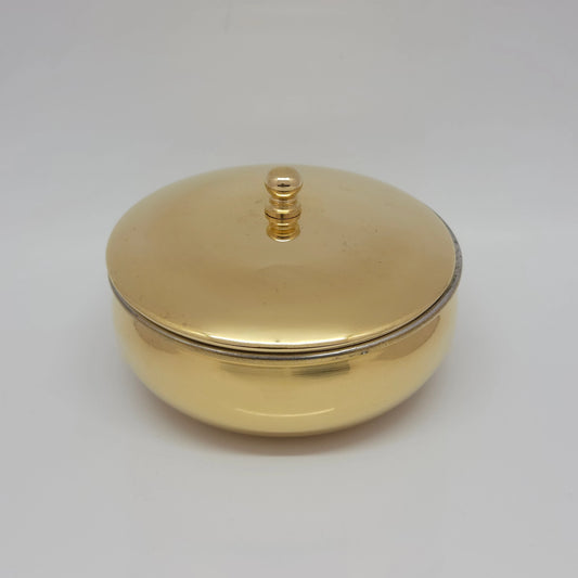 Front view of the pure brass Urli bowl showing the lid closed flat with its vertical knob highlighting the smooth, high-gloss golden polish.