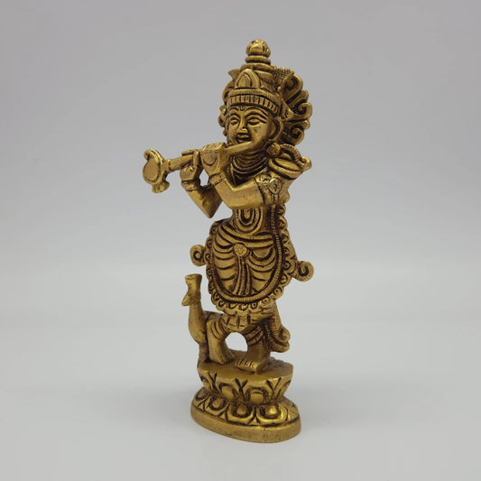 Left 45-degree angle profile emphasizing Krishna's three-bend posture, arm placement, and the finely detailed peacock companion.