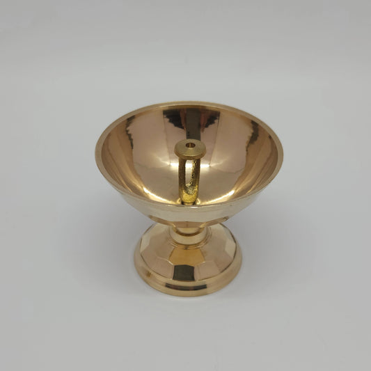 Top down angle view of the brass diamond cut oil lamp bowl showcasing the polished inner basin and the built-in central wick pillar stand