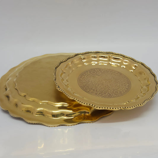 Front and Back perspective view showcasing a stacked row collection of different sizes of the premium solid brass royal pebble engraved pooja plate.