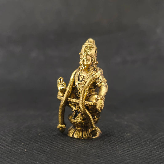 Three-quarter front right perspective view of the brass Swami Ayyappan statue showcasing his open palm blessing posture and the detailed weave of the yogapatta knee band.