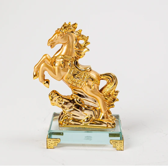 13cm premium luxury gold paint finish resin Feng Shui rearing victory horse statue with a polished ceremonial saddle on a clear crystal base by Sri Swaminathan and Co