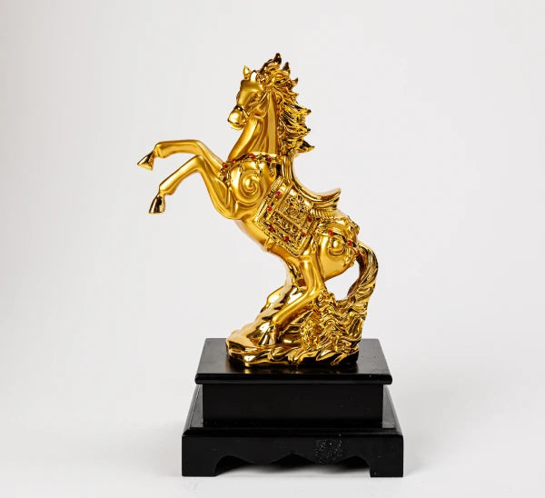 22cm premium luxury gold paint finish resin Feng Shui rearing stallion statue with crimson gem accents on a thick stepped black platform base by Sri Swaminathan and Co