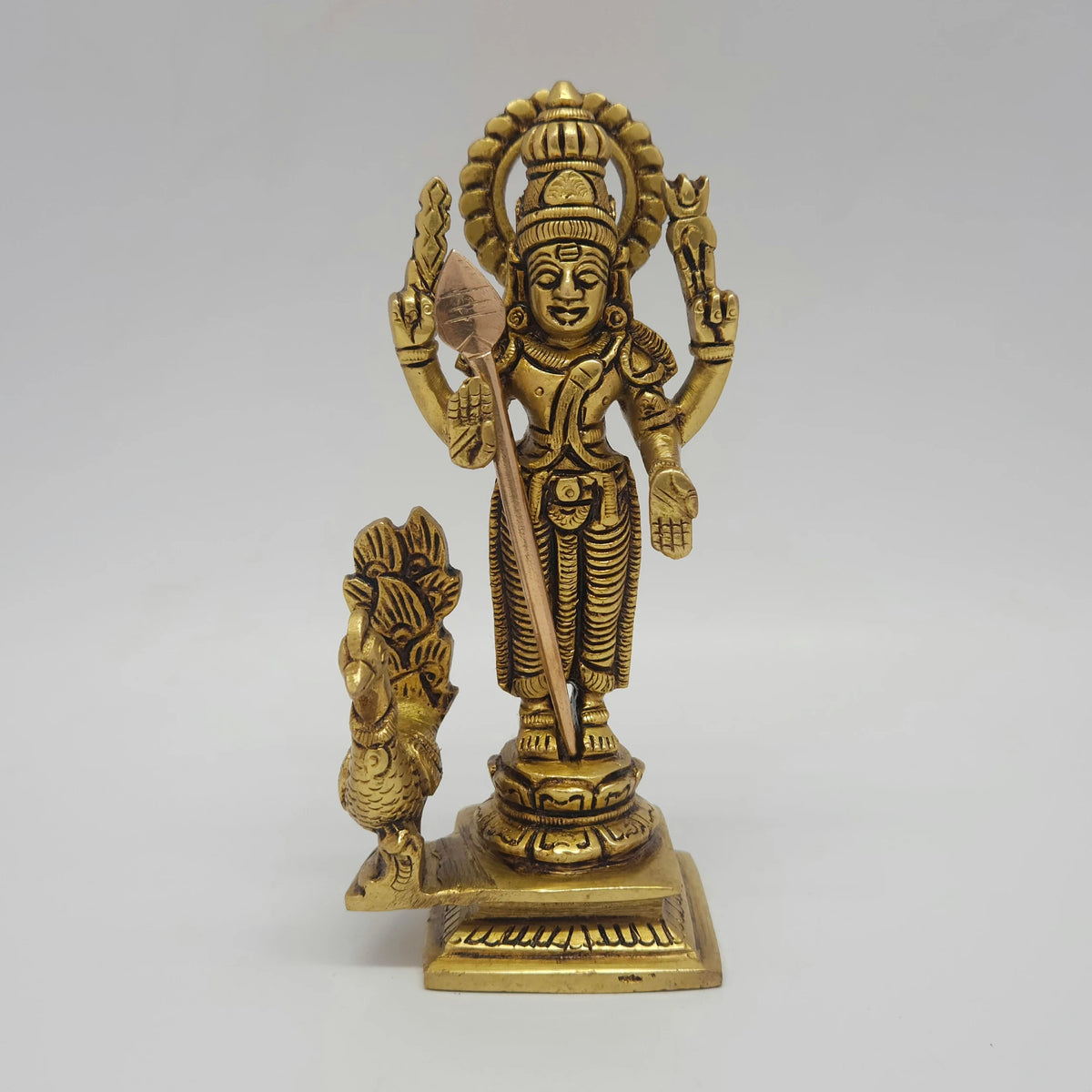 Alternative straight front profile view of the six point one inch brass Swaminatha Swami statue highlighting the natural light glints reflecting off the polished inner contours.