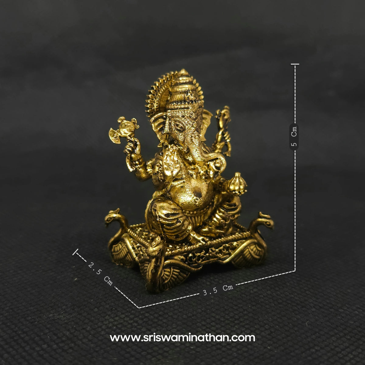 Front perspective measurement photo of the two inch solid brass Ganesha statue next to a scale demonstrating the five centimeter height and compact micro altar dimensions