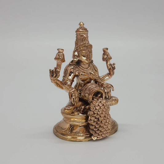Sri Swaminathan and Co handcraft style Panchaloha Dhana Lakshmi statue 8.5cm height 45 degree left pose corner view highlighting lotus stalk and tilted coin pot