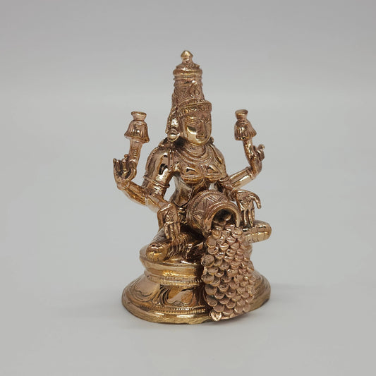 Sri Swaminathan and Co handcraft style Panchaloha Dhana Lakshmi statue 8.5cm height 45 degree left pose corner view highlighting lotus stalk and tilted coin pot