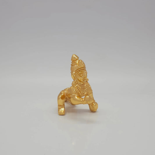 Sri Swaminathan and Co brass crawling Baby Krishna showpiece gold finish 100g weight 45 degree right pose corner view focusing on hand holding laddu sweet and body depth