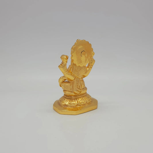 Sri Swaminathan and Co brass miniature Mahalakshmi statue gold finish 275g weight back pose 45-degree rear view showing reverse of radiating crown halo and octagonal base platform