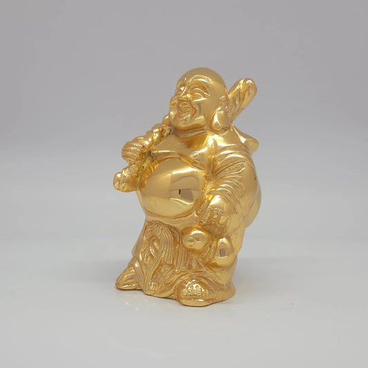Sri Swaminathan and Co brass standing Laughing Buddha showpiece gold finish 1kg weight 45 degree left pose corner view highlighting the chiseled cloth sack curves and shoulder placement