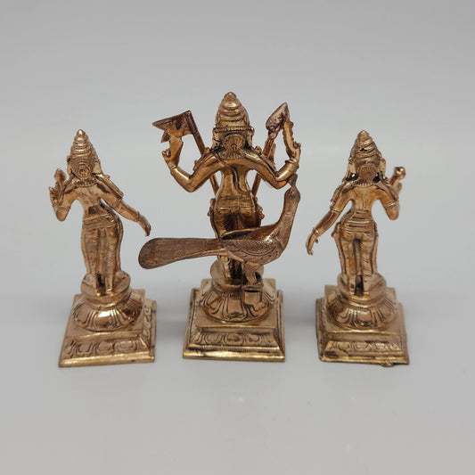 High angle back view of the handmade five-metal Lord Murugan idol trio highlighting the fine facial features and metal casting details.