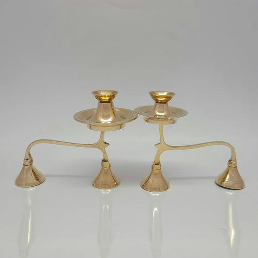Two genuine brass camphor aarti stands with handles placed side by side to highlight the design details of the extra storage disk.