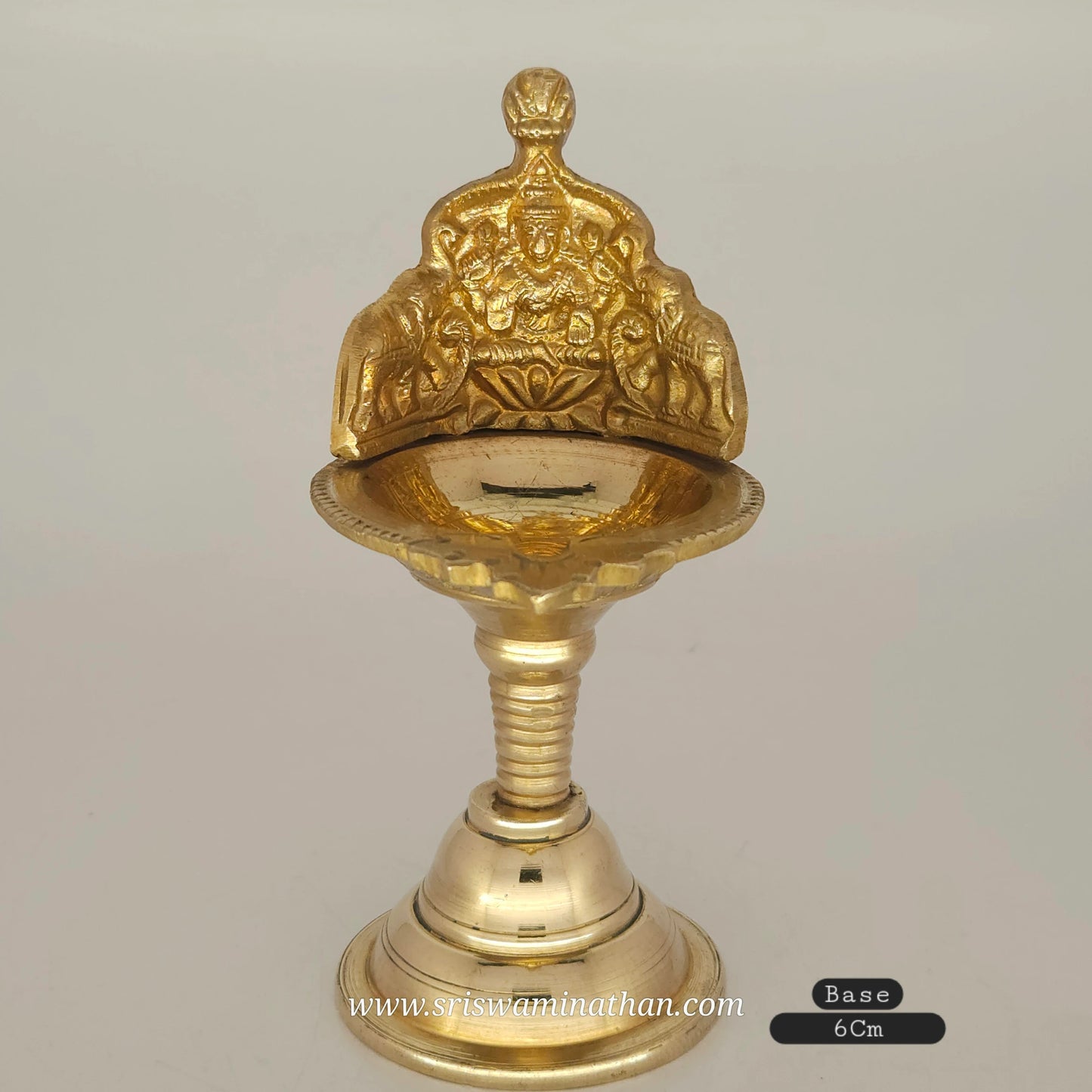 Close-up view of Gaja Lakshmi brass lamp showing intricate elephant and goddess details