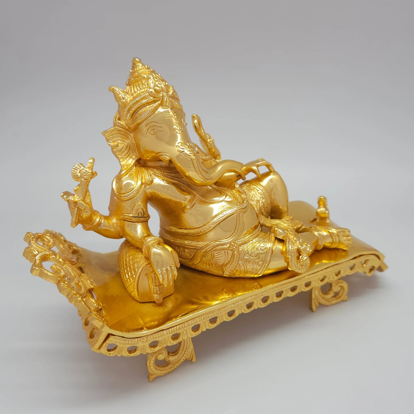 Premium Brass Reclining Vilasina Lord Ganesha Murti on Carved Royal Couch and Bolster Bed – Durable Gold Powder Coated Finish – 10.6" (27 cm Length) | Sri Swaminathan & Co