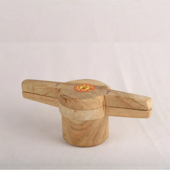 A wooden achi (a type of traditional Indian dish) presented against a white background, showing a natural wood finish with a small round branded label on the top.
