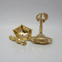 The 8-inch brass peacock vilakku shown in pieces to demonstrate how it untwists for easy washing.