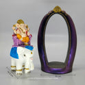 Front angle comparison showing the white elephant piece standing next to the empty purple archway stand
