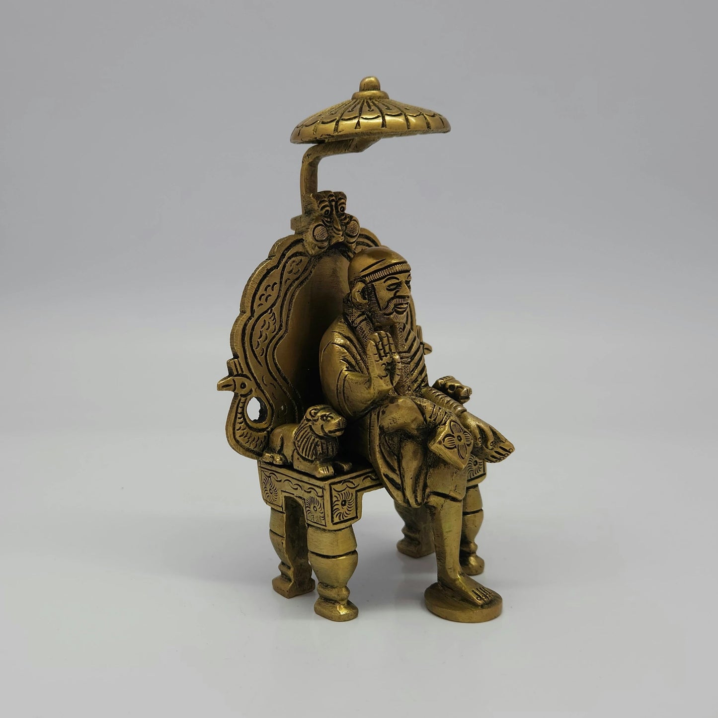 Antique Brass Shirdi Sai Baba Statue 45 degree front right profile showing side lion pillar and footrest