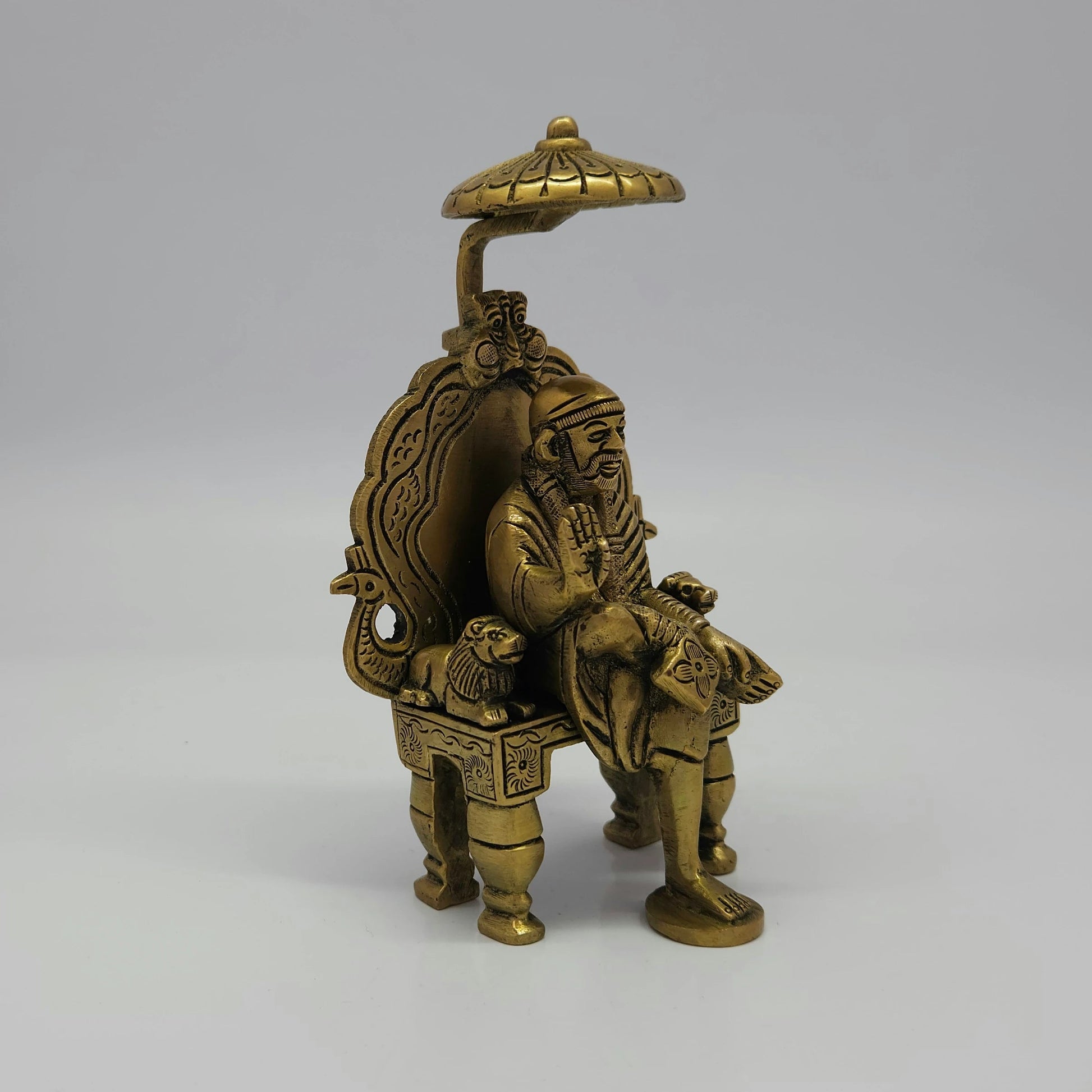 Antique Brass Shirdi Sai Baba Statue 45 degree front right profile showing side lion pillar and footrest