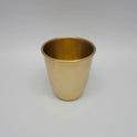 Slightly high angle view showing the smooth rim and 300ml capacity of the matte brass glass.