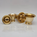 Group layout featuring one overturned brass chandan katori showing the hollow pedestal base cavity alongside other upright sandhanam ginni cups