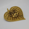 Three-quarter side angle view of the brass Ganesha betel leaf piece highlighting the 0.5 cm material thickness, leaf stem design, and deep casting relief lines.