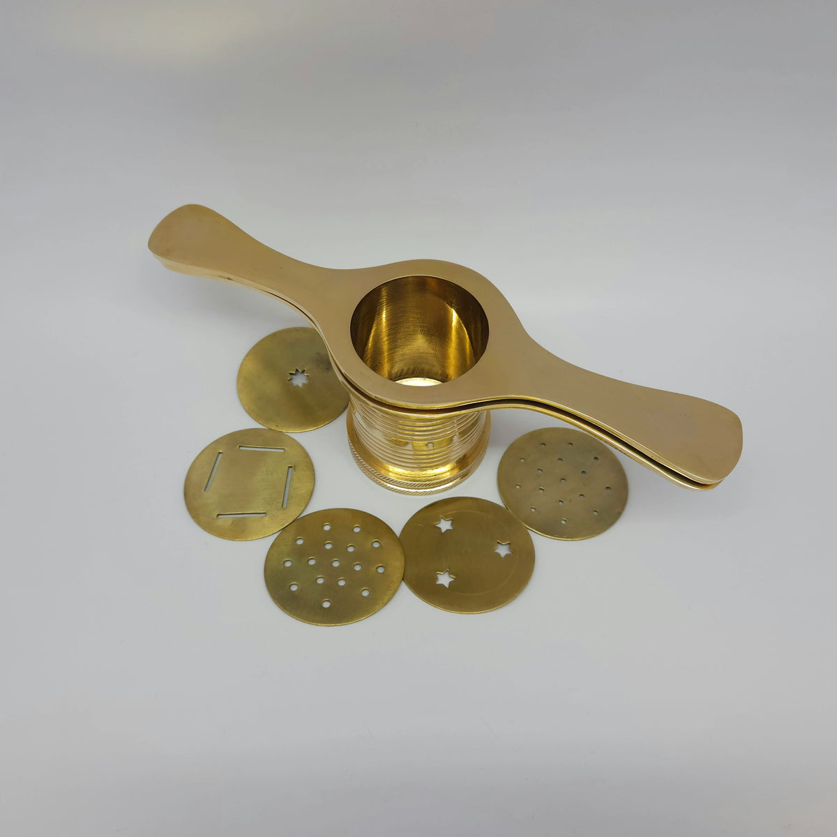 Top down view of open solid brass sevanazhi cylinder highlighting the wide interior compartment chamber and jali molds.