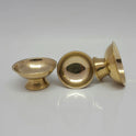 Three brass offering bowls with one turned sideways to show the interior depth and the flat surface of the hollow pedestal base.