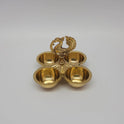 High angle view of the brass peacock four-cup container used for holding pooja powders.