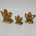 Slightly high-angled studio shot of the antique gold finish Chaturbhuja Vinayagar statues displaying the overall depth and stable structural profiles of the square pedestals.