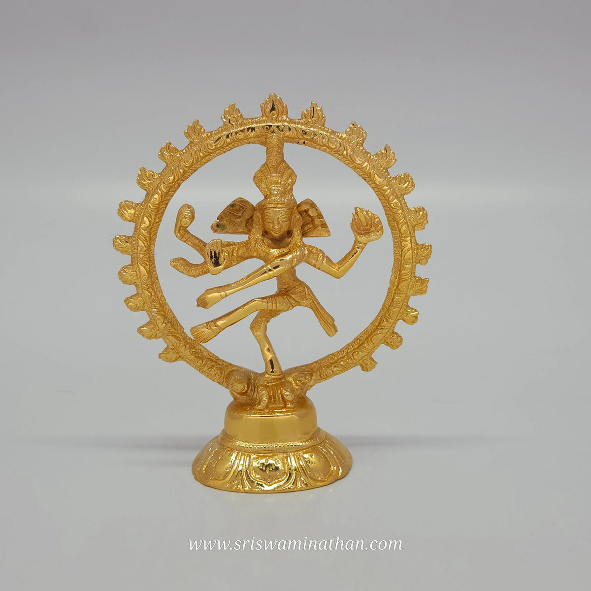Direct front view of a pure brass Shiva Nataraja statue featuring a glossy gold layered coating, dancing inside a fiery circular halo