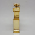 Back view profile of the 7 inch brass Swastik oil lamp standing upright on a flat surface.