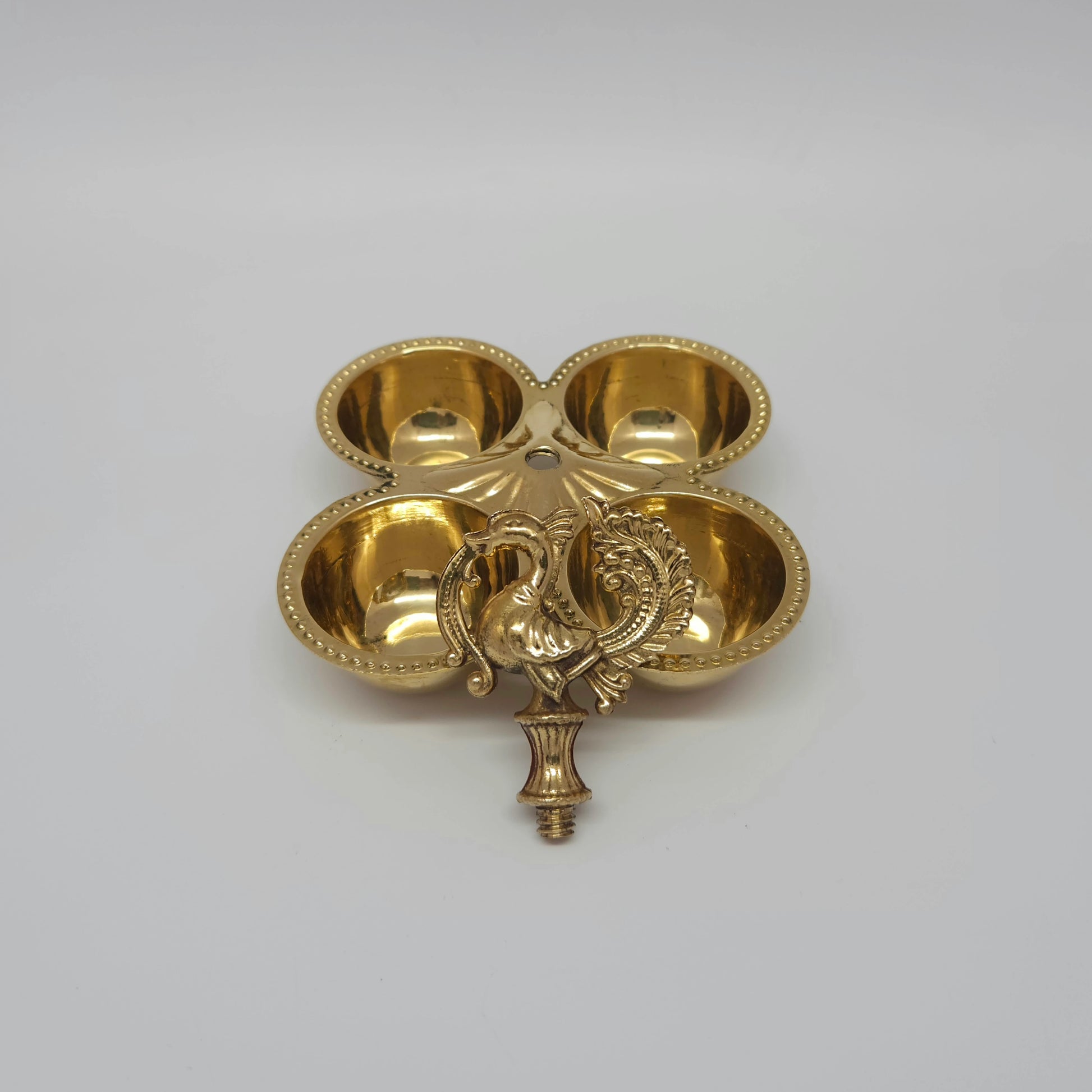 Top-down view showing the four round cup sections and the neat central peacock handle.