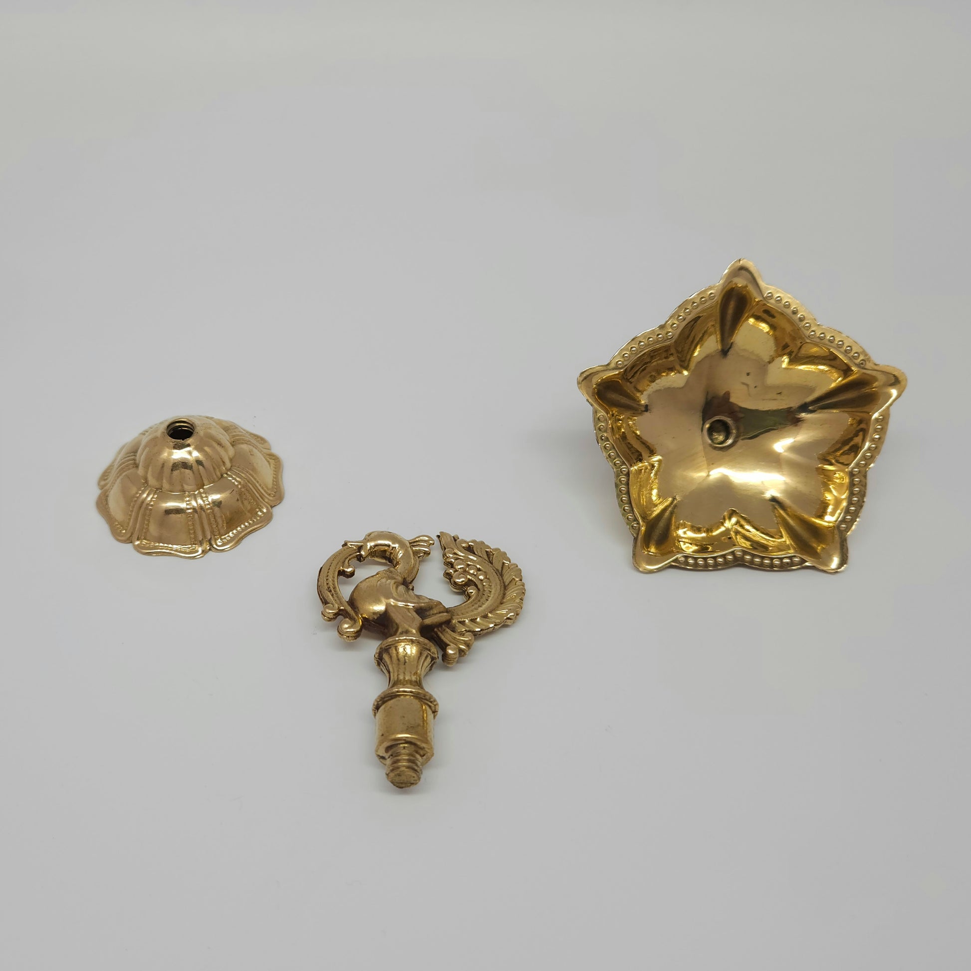 The pure brass peacock lamp taken apart into three separate pieces to show how easy it is to wash