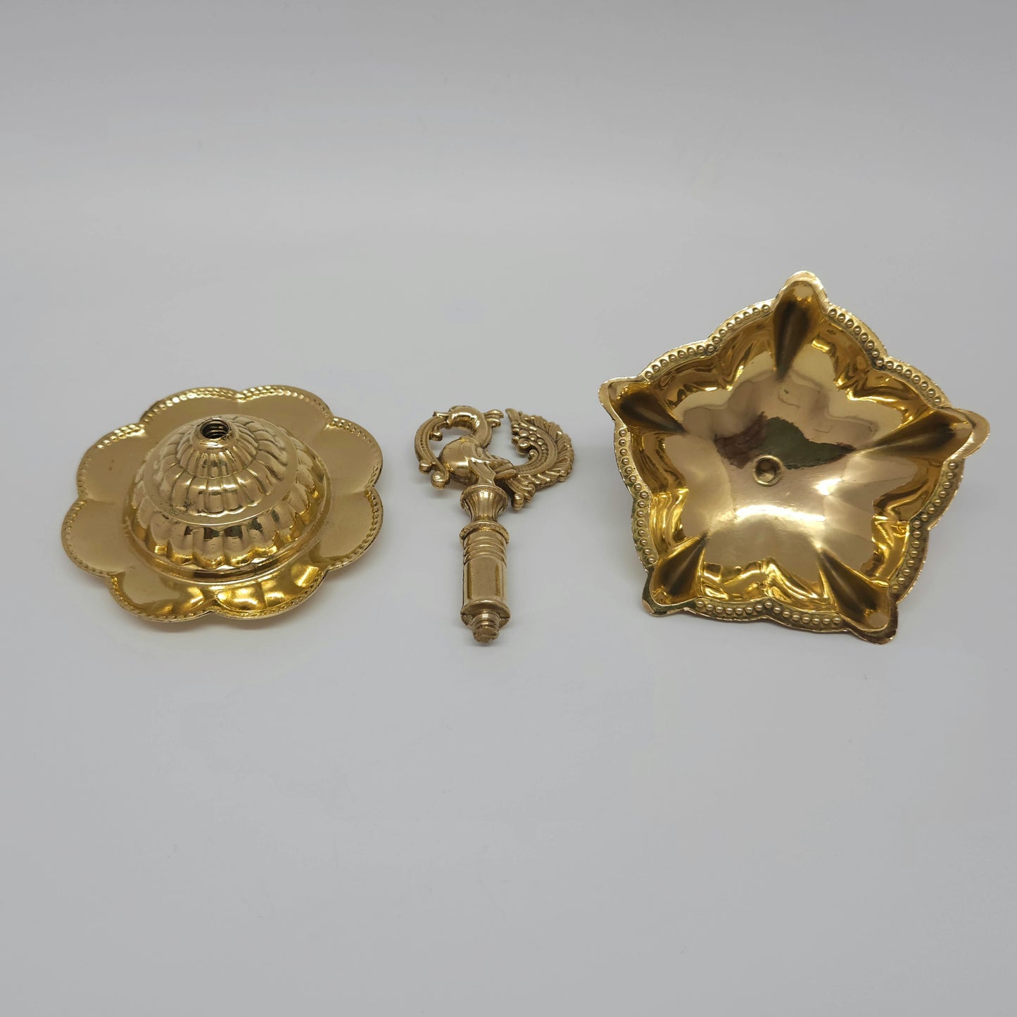 The flower base brass peacock lamp taken apart into three pieces to show how easy it is to wash.