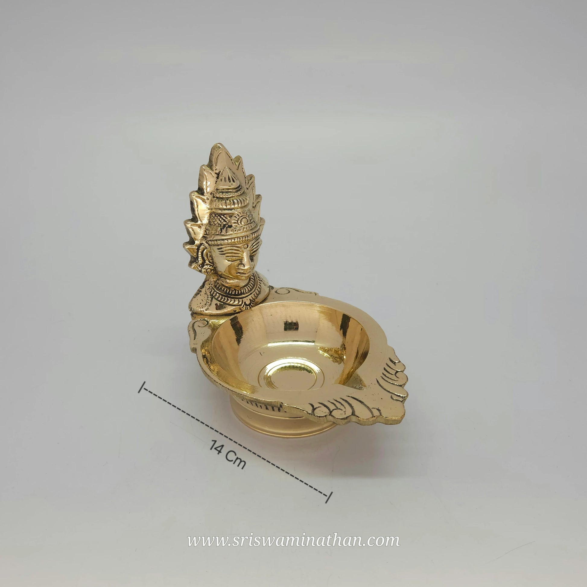Side view of Amman vilakku showcasing Devi Shakti lamp design and brass work details