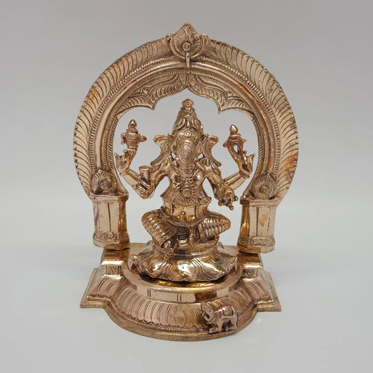 Front straight profile view of the 6.3 inch authentic Swamimalai Panchaloha seated Ganesha statue showing the detailed removable Prabhavali arch, lotus pedestal, and Mooshika mouse base from Sri Swaminathan and Co stock