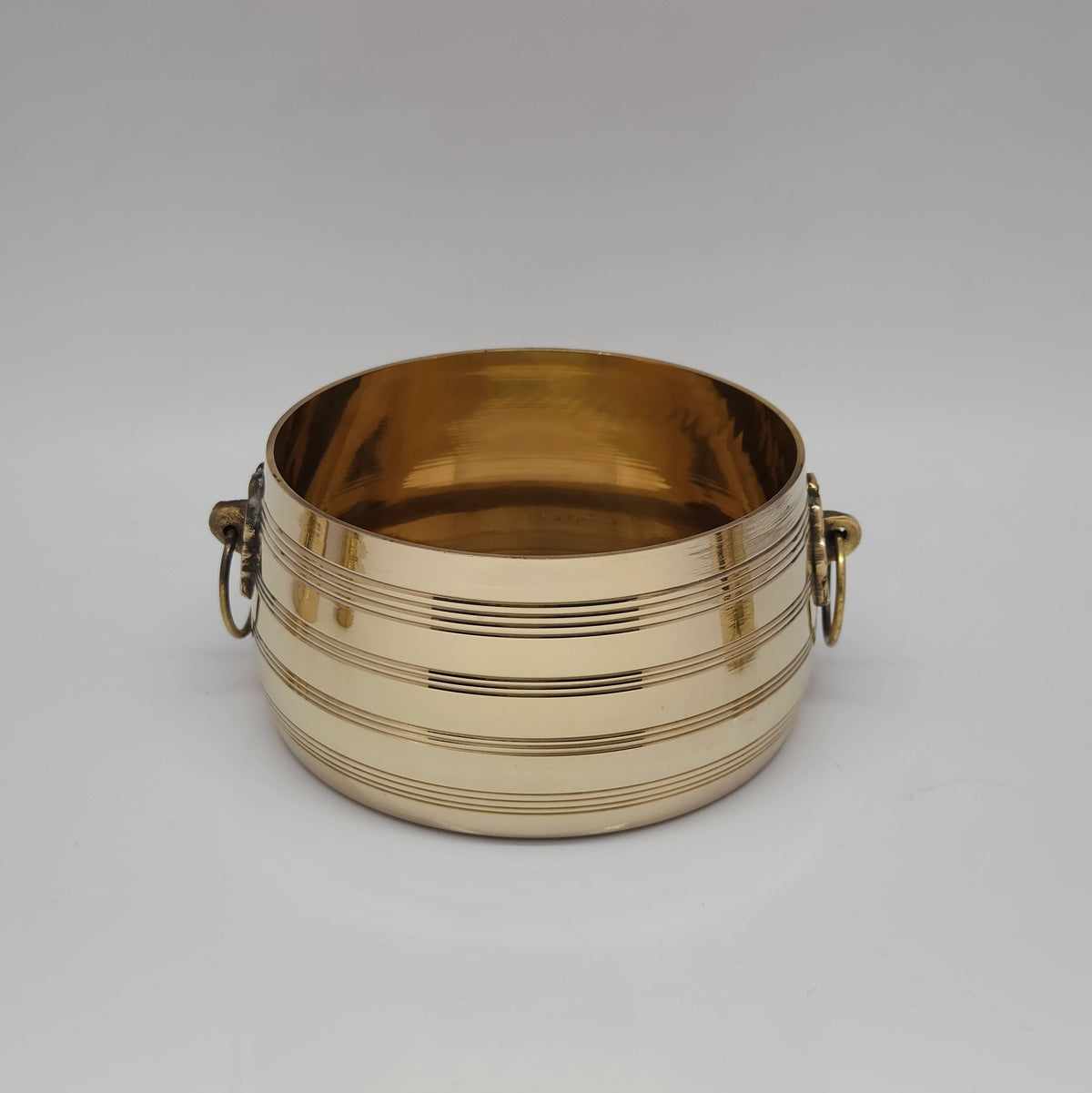 Standalone front view of the large master brass cheeri uruli container showcasing the thick heavy-duty build and prominent side loops.
