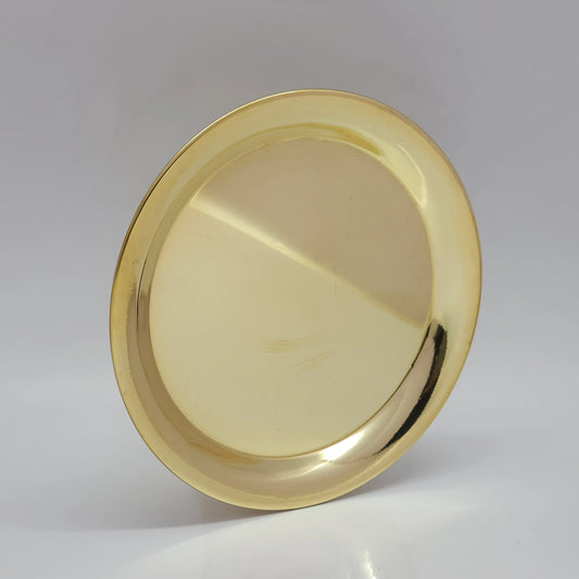 Three-quarter tilted perspective view of pure brass plain plate showcasing the shallow basin depth and structural outer rim.