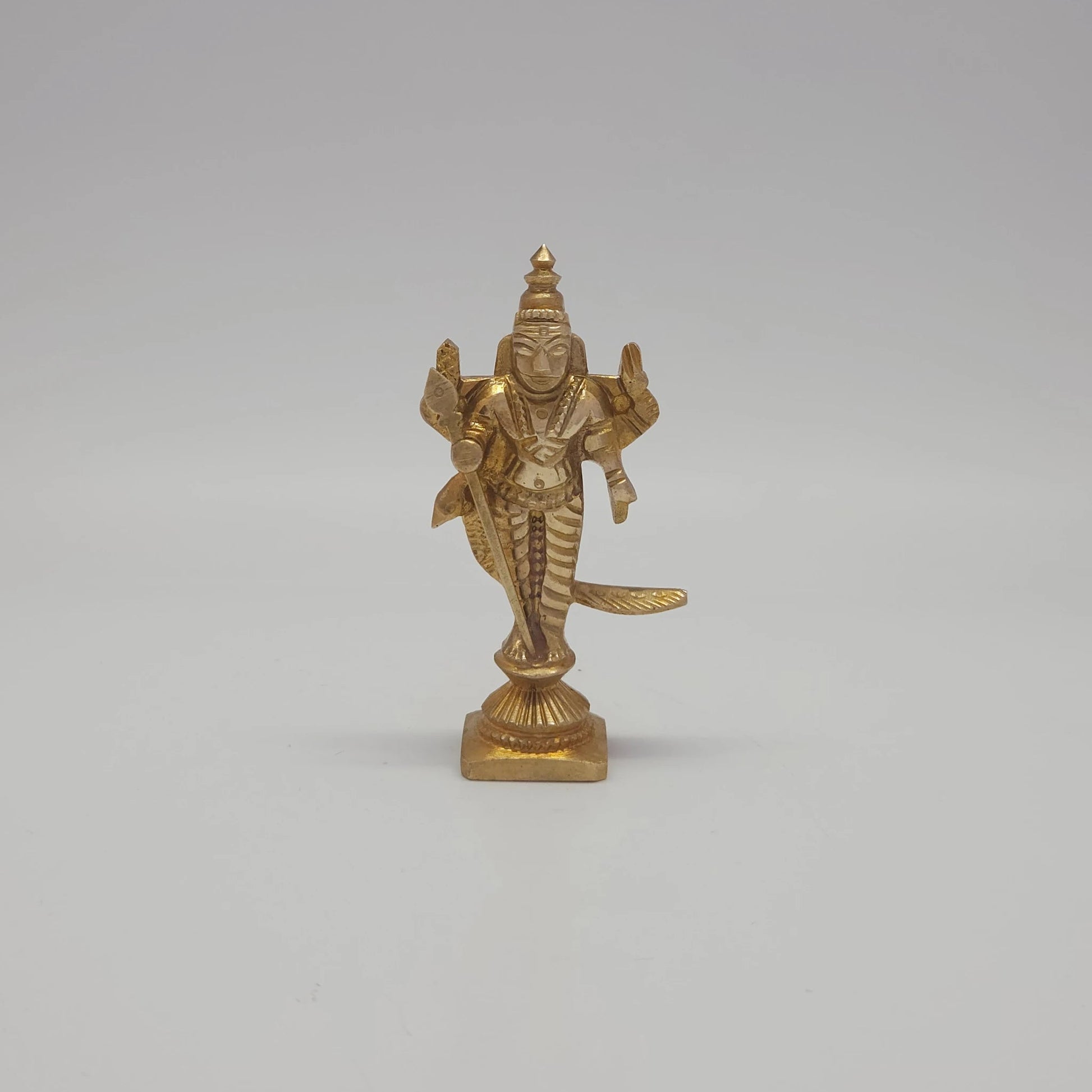 Front view of the 6.5cm handcrafted miniature solid brass Murugan statue with Vel and peacock on a square base by Sri Swaminathan & Co for daily puja rituals.