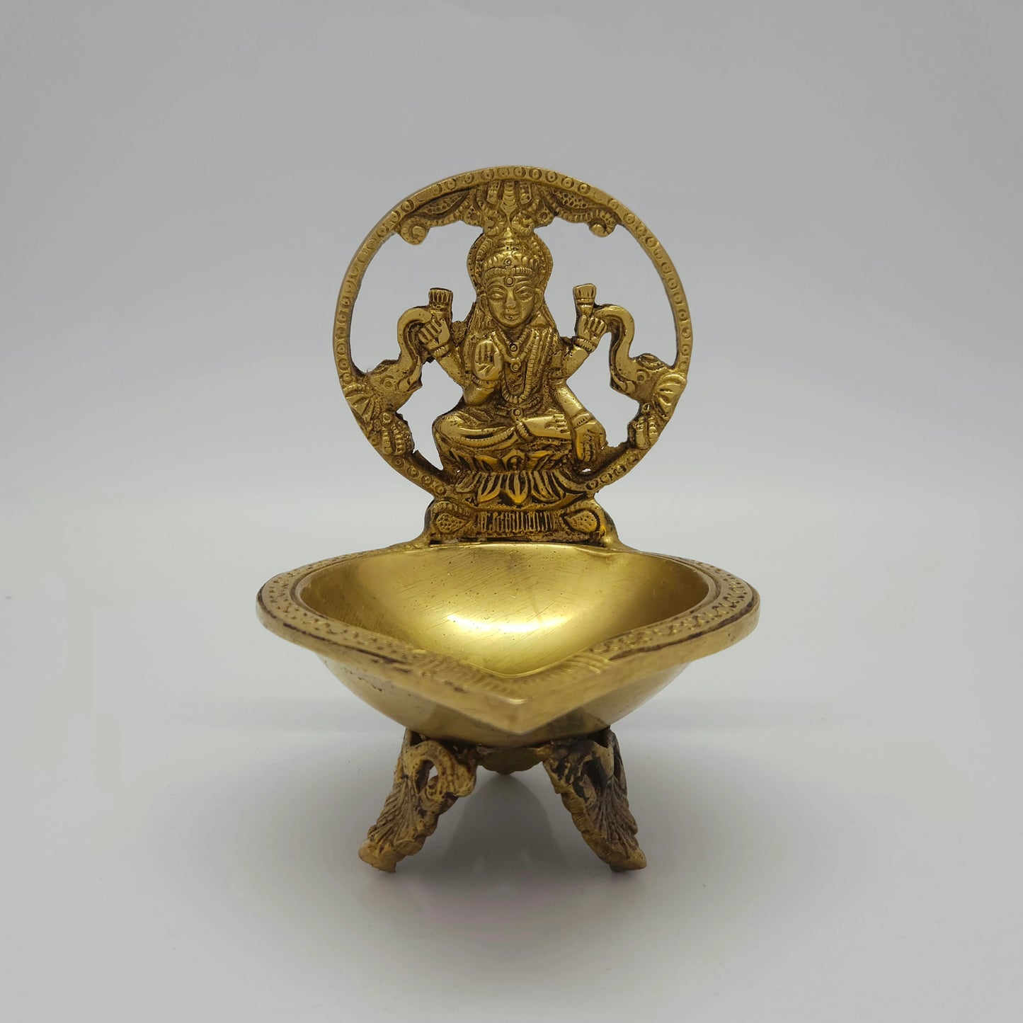 Flat straight front view of the 16.5cm high antique solid brass Gajalaksmi Kamatchi Deepam altar oil lamp
