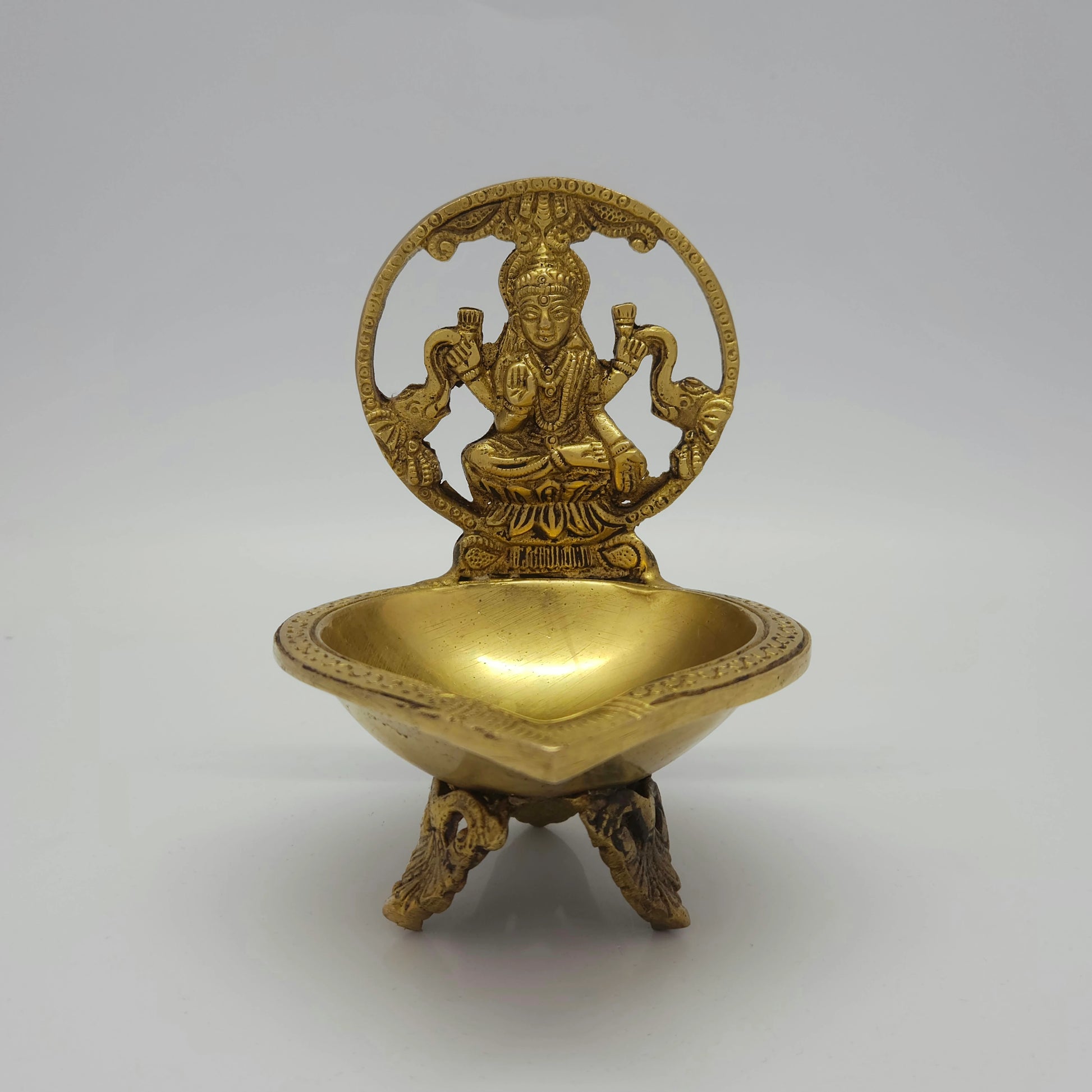 Flat straight front view of the 16.5cm high antique solid brass Gajalaksmi Kamatchi Deepam altar oil lamp