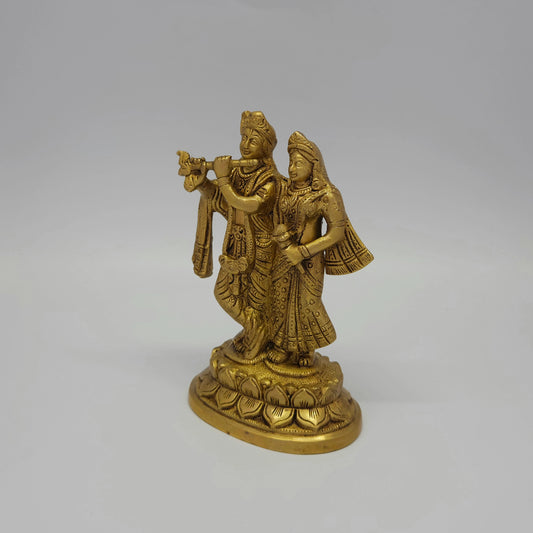Front-left 45-degree angle profile view showcasing Krishna's flute alignment, detailed crown lines, and the deep metal shadows of the antique finish.