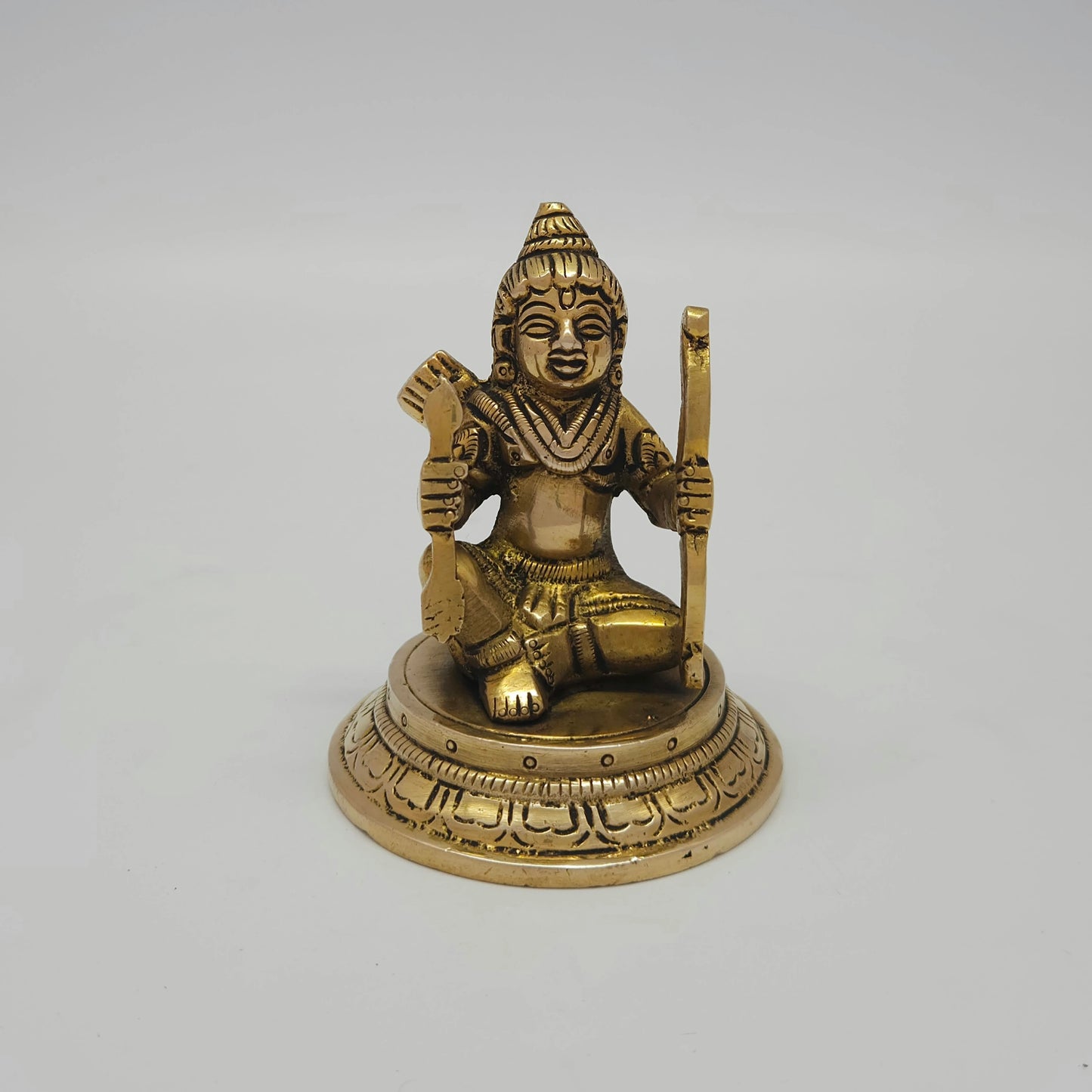 Flat straight front view of the 8.5cm small antique solid brass seated Kodanda Rama statue on a round lotus base for daily puja rituals