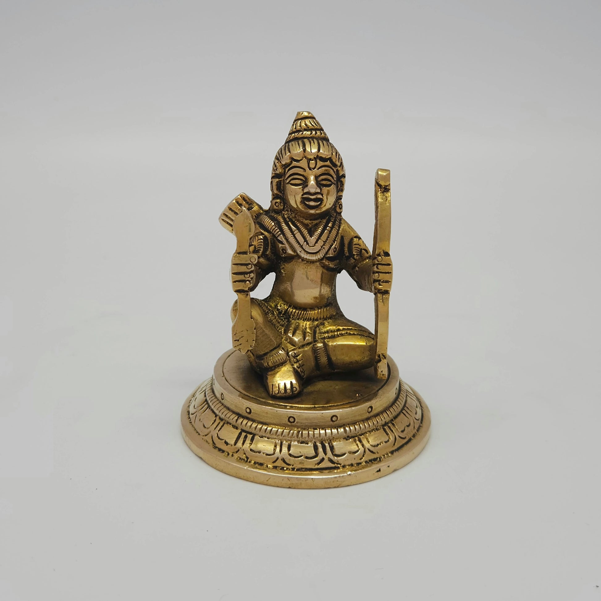 Flat straight front view of the 8.5cm small antique solid brass seated Kodanda Rama statue on a round lotus base for daily puja rituals