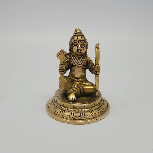 Flat straight front view of the 8.5cm small antique solid brass seated Kodanda Rama statue on a round lotus base for daily puja rituals