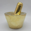 Flat straight front view showing the Kuzhavi muller resting inside the brass Aatukkal bowl for traditional marriage rituals