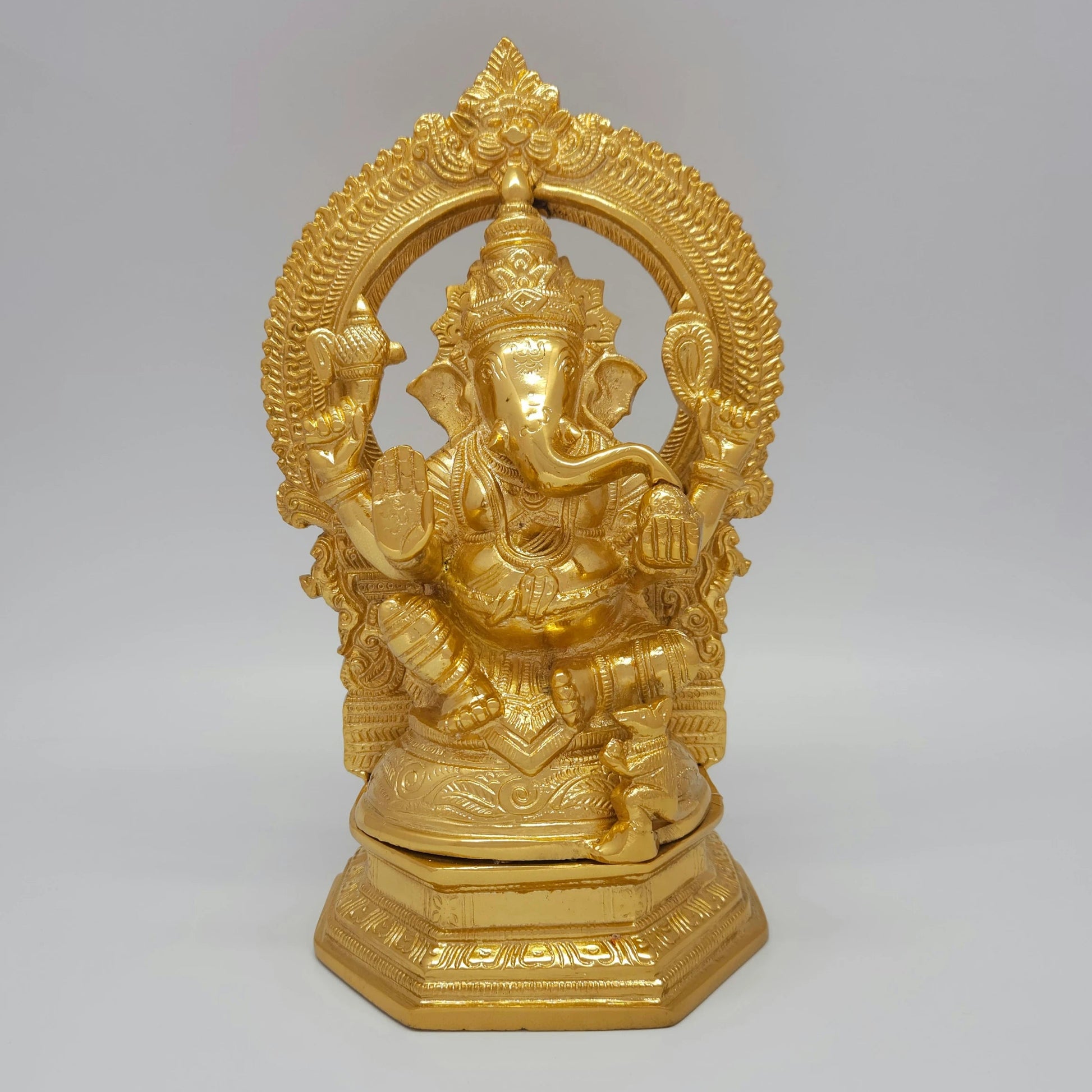 Front view of the 25.5cm premium high-gloss gold brass Idampuri Vinayagar statue with temple archway for luxury home entrance decor.